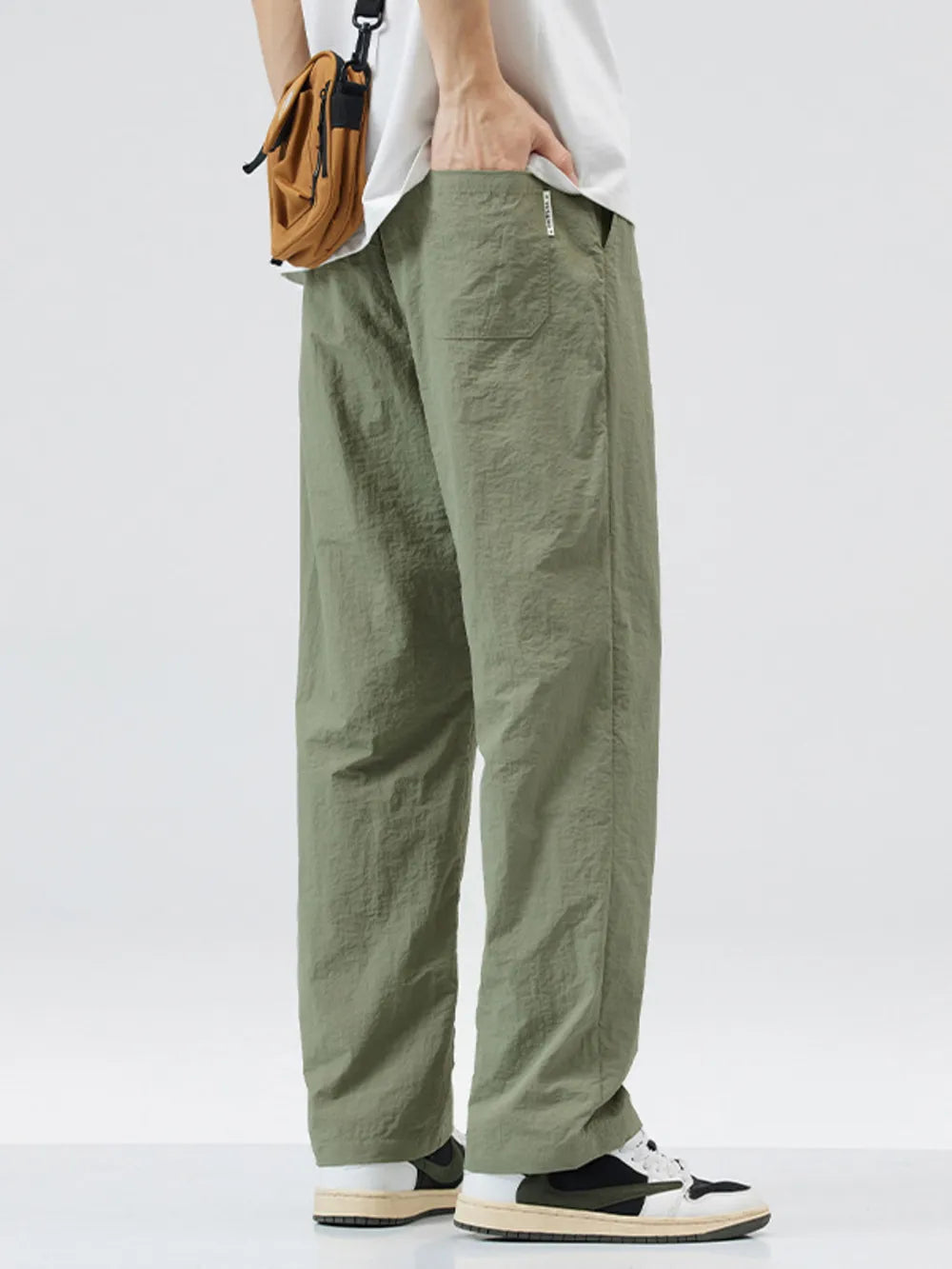 Relaxed fit wide-leg sweatpants in sage green with a textured finish and pockets.