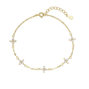 Gold delicate bracelet with four-leaf clover charms and crystal accents