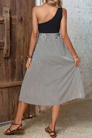 Black one-shoulder midi dress with asymmetric bodice and vertical stripe skirt with bow detail