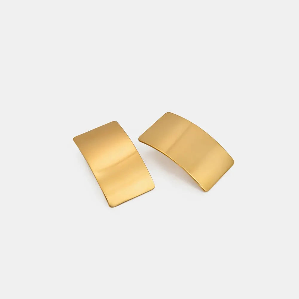 Sculpted gold-tone statement earrings with a bold, curved design.