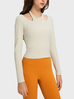 Ivory ribbed long sleeve sport top with cutout shoulders and crew neck.