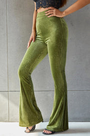 Ribbed velvet palazzo trousers in matcha green with a flared leg.