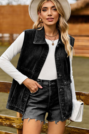 Sleeveless dark denim utility vest with button front and chest pockets.