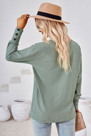 Sage green textured V-neck blouse with button cuff detail