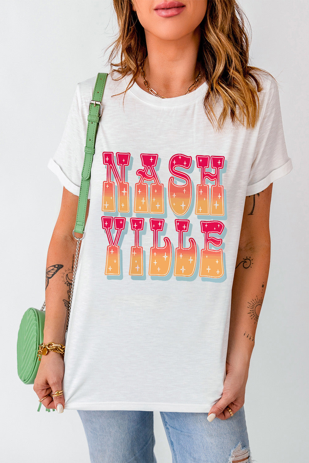 White t-shirt with Nashville Sunset typography graphic, crew neck, short sleeves.