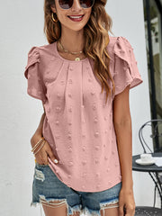 Pink textured puff sleeve blouse with dot pattern and pleated neckline.