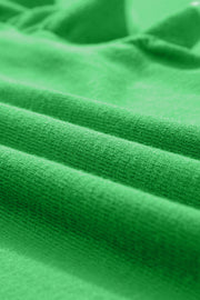 Green knit cardigan with ruffled sleeves and contrast trim detail