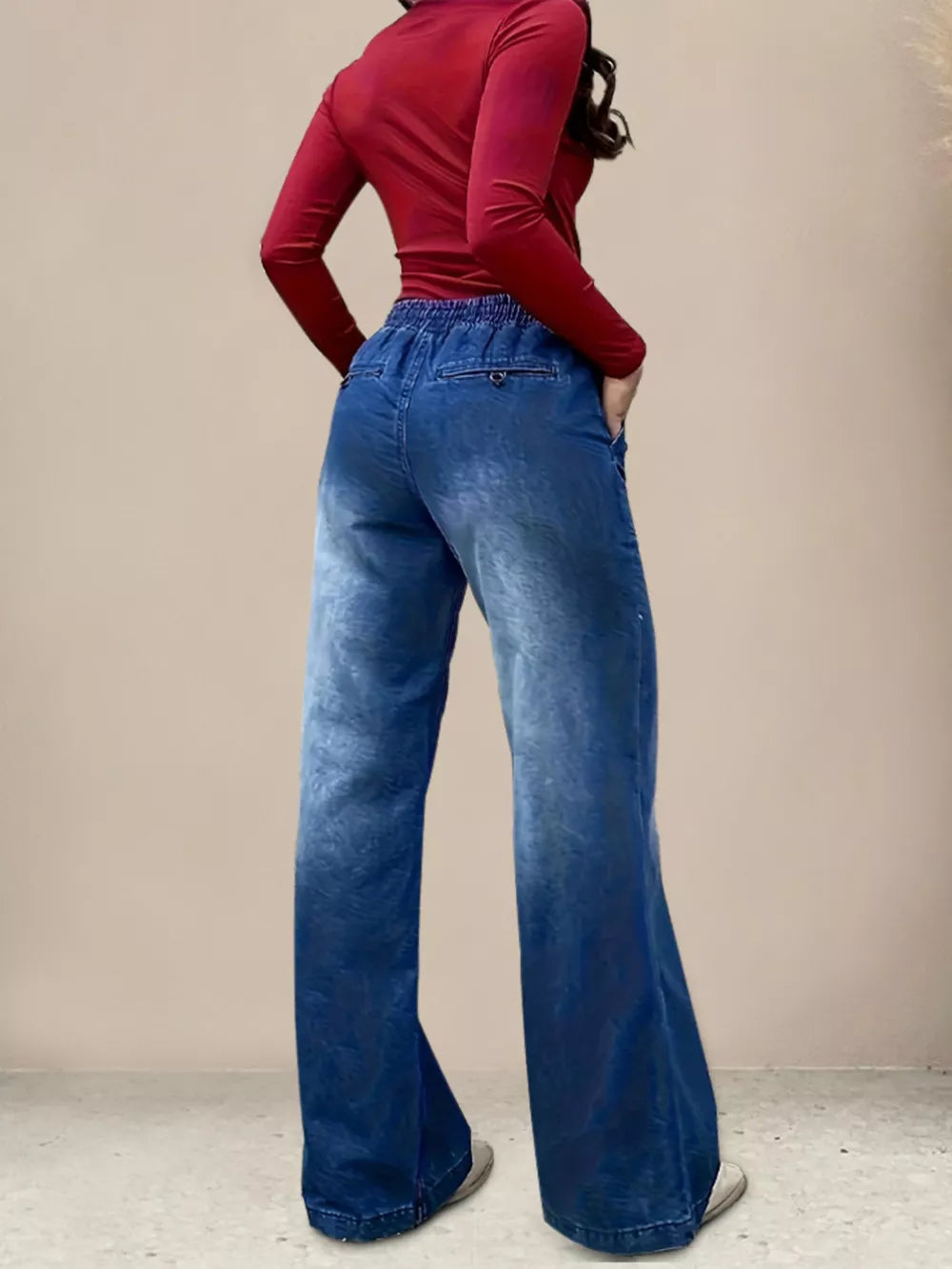 Light blue denim maternity jeans with drawstring waist and wide legs.