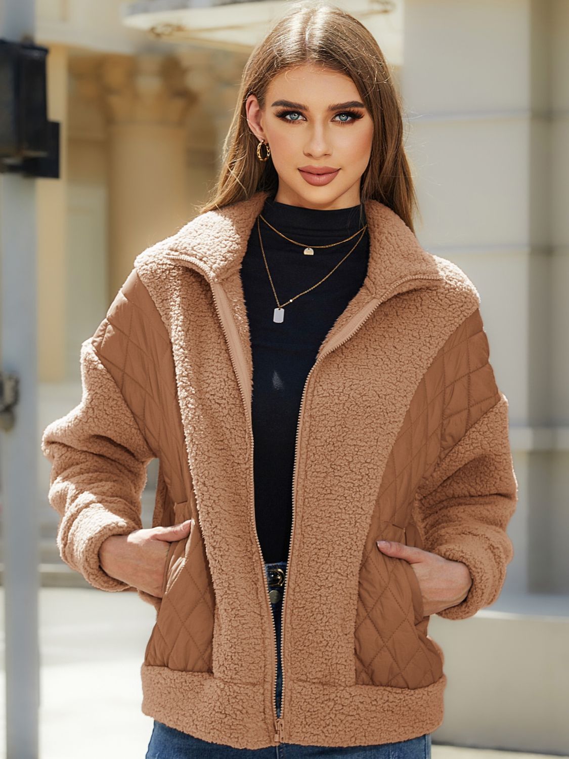 Camel quilted jacket with sherpa panels and zip front, featuring a stand-up collar.