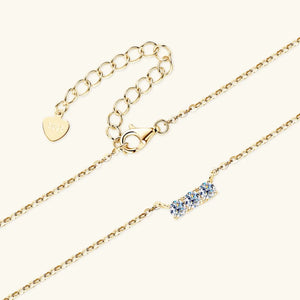 Gold bar necklace with three moissanite stones and adjustable chain.