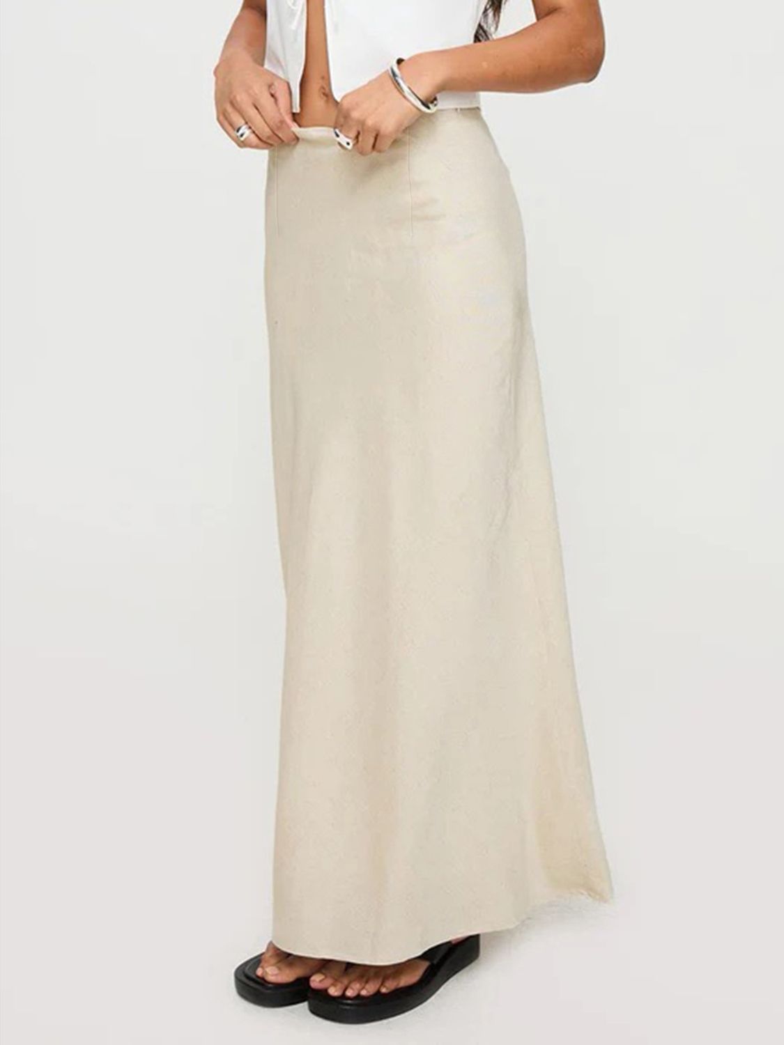 Beige bias-cut maxi skirt with a smooth finish and a flowing silhouette.
