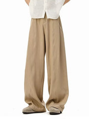 Men's khaki wide-leg track pants with front seams and pockets.