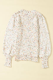 Speckled puff sleeve knit sweater in cream with colorful speckles and ribbed cuffs.