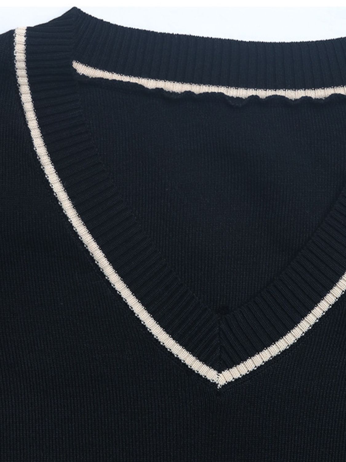 Black knit v-neck sweater with contrast trim and scalloped neckline detail