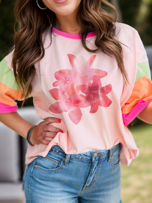 Colorblock floral t-shirt in watermelon pink with pink trim and colorful sleeves.