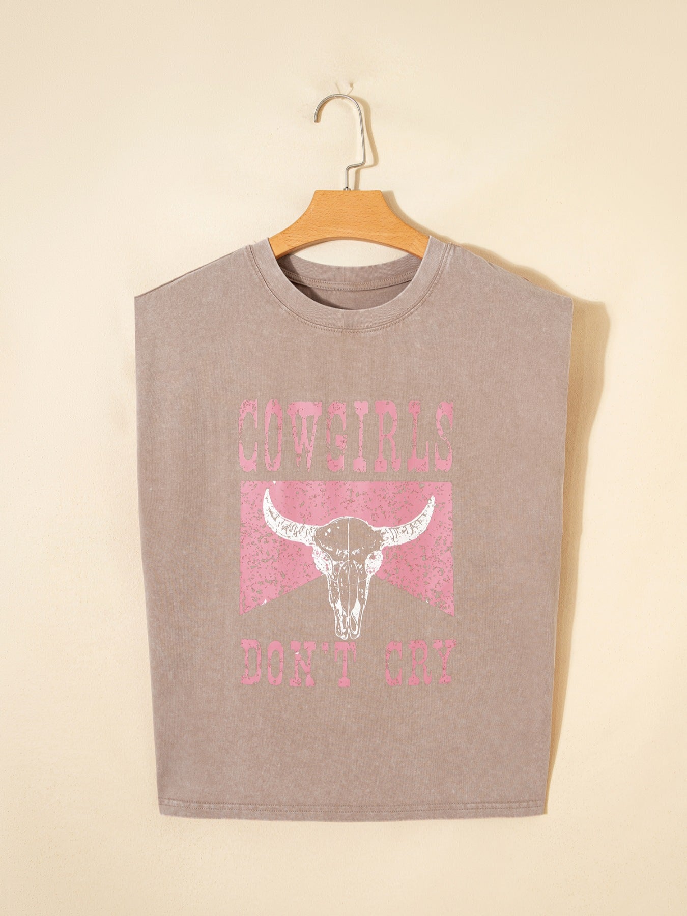 Acid-washed cotton tank top in khaki with cowgirl skull graphic and text.