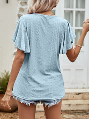 Light blue eyelet flutter sleeve blouse with textured pattern.