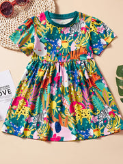 Toddler a-line dress with short sleeves and a playful jungle animal print in green, yellow, pink, and blue.