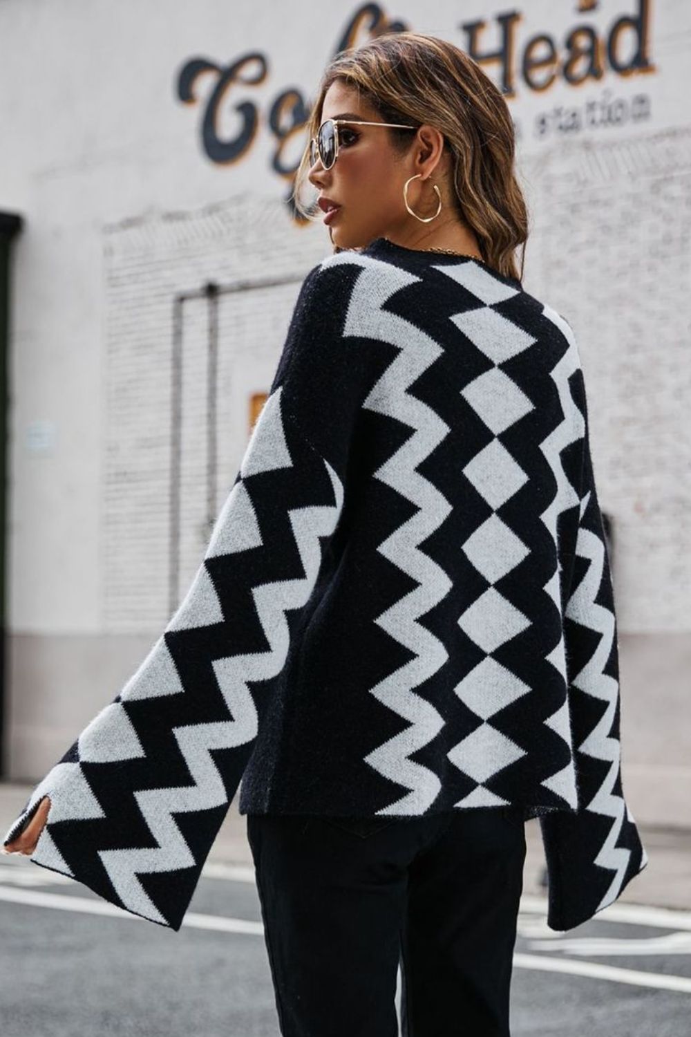 Black chevron knit sweater with bell sleeves and a relaxed fit.