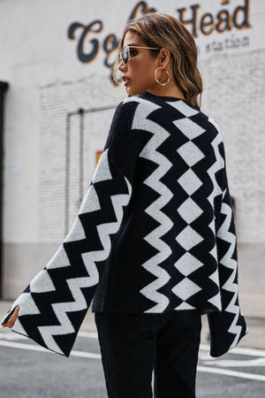 Black chevron knit sweater with bell sleeves and a relaxed fit.