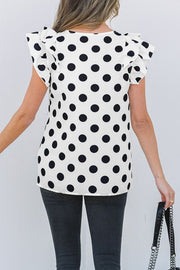 Polka dot blouse with flutter sleeves and V-neck.