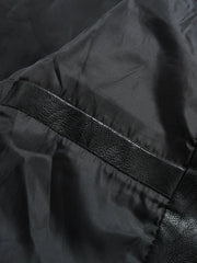 Black moto jacket detail with faux leather trim and satin lining.