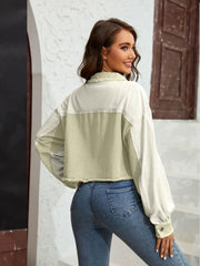 Textured colorblock cropped jacket in matcha green and cream with raw edges and balloon sleeves.
