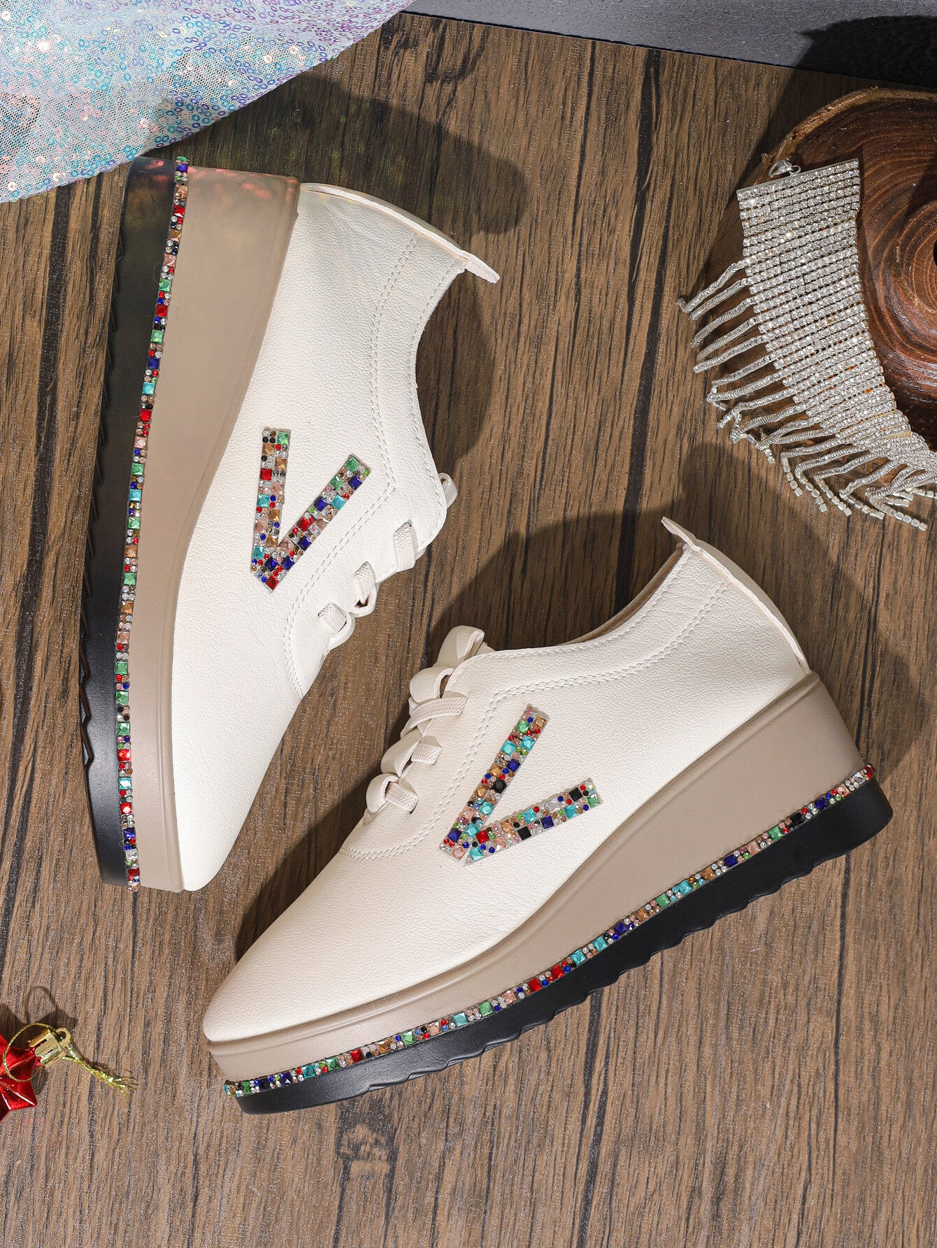 White leather wedge sneakers with colorful rhinestone V logo and embellished sole.
