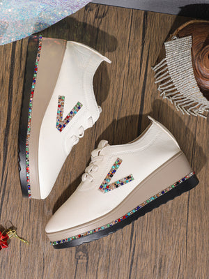 White leather wedge sneakers with colorful rhinestone V logo and embellished sole.