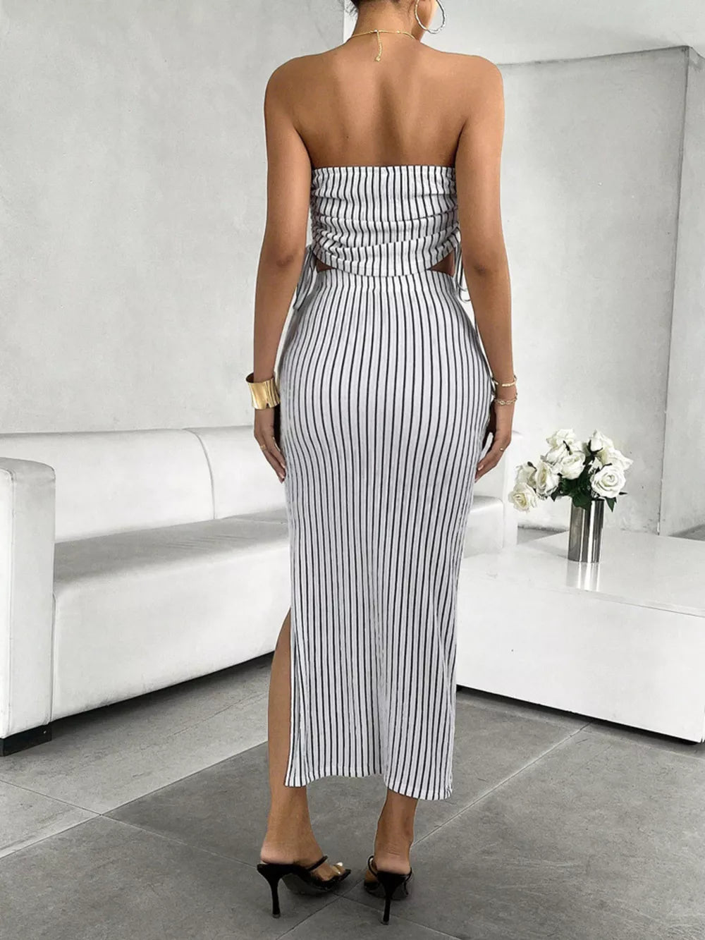 Black and white striped tube top and slit maxi skirt set with cutouts.