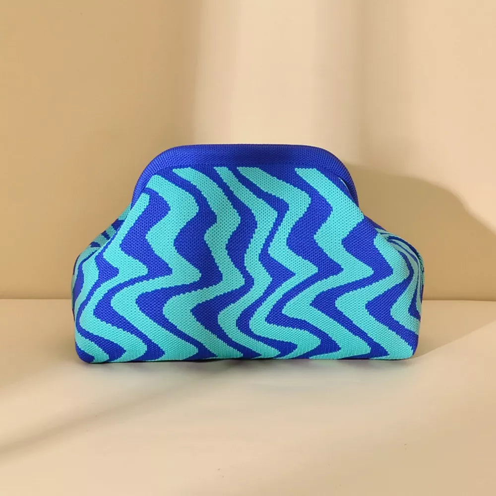 Vibrant knit clutch with striking blue and aqua zig-zag stripes.