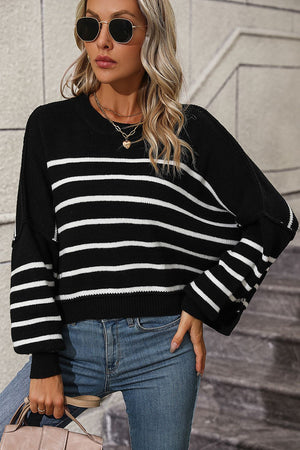 Black and white striped boxy knit sweater with crew neck and long sleeves.