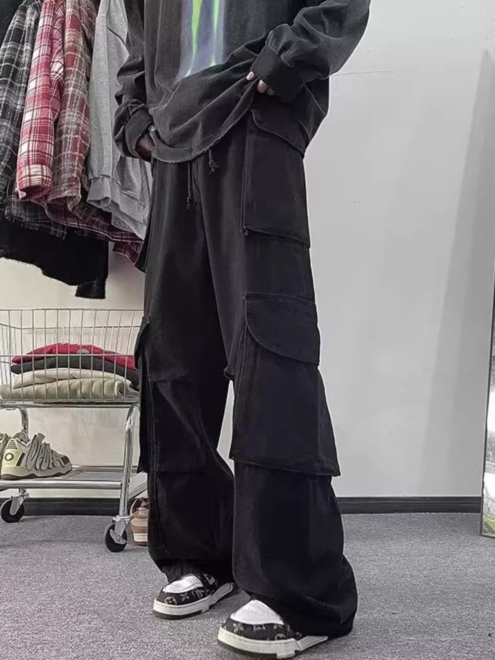 Black cargo pants with multiple large pockets and a relaxed fit.