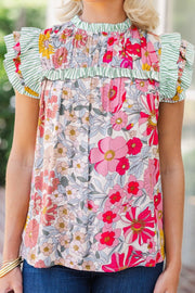 Floral blouse with ruffle sleeves, smocked bodice, and green stripe trim.