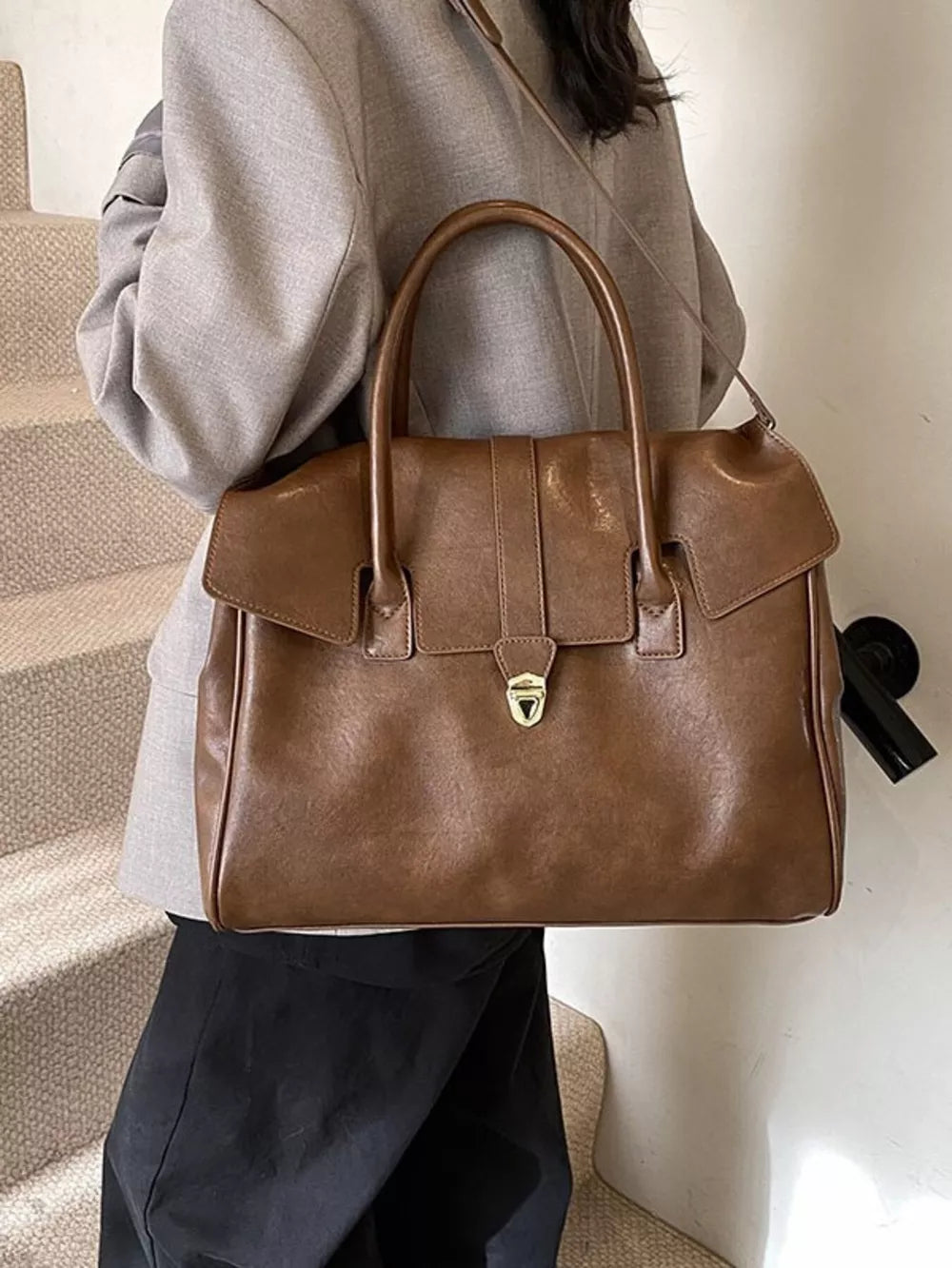 Dark brown pu leather tote bag with sleek buckle detail and top handles.