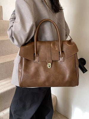 Dark brown pu leather tote bag with sleek buckle detail and top handles.