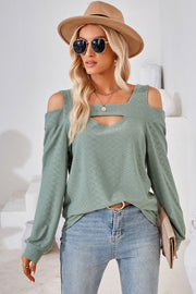 Light green geometric cutout shoulder top with a square neckline and long sleeves.