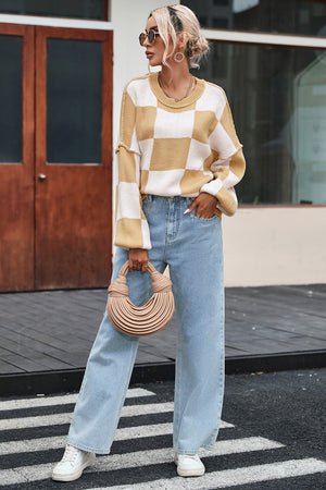 Checkerboard knit relaxed crewneck sweater in tan and white with balloon sleeves.