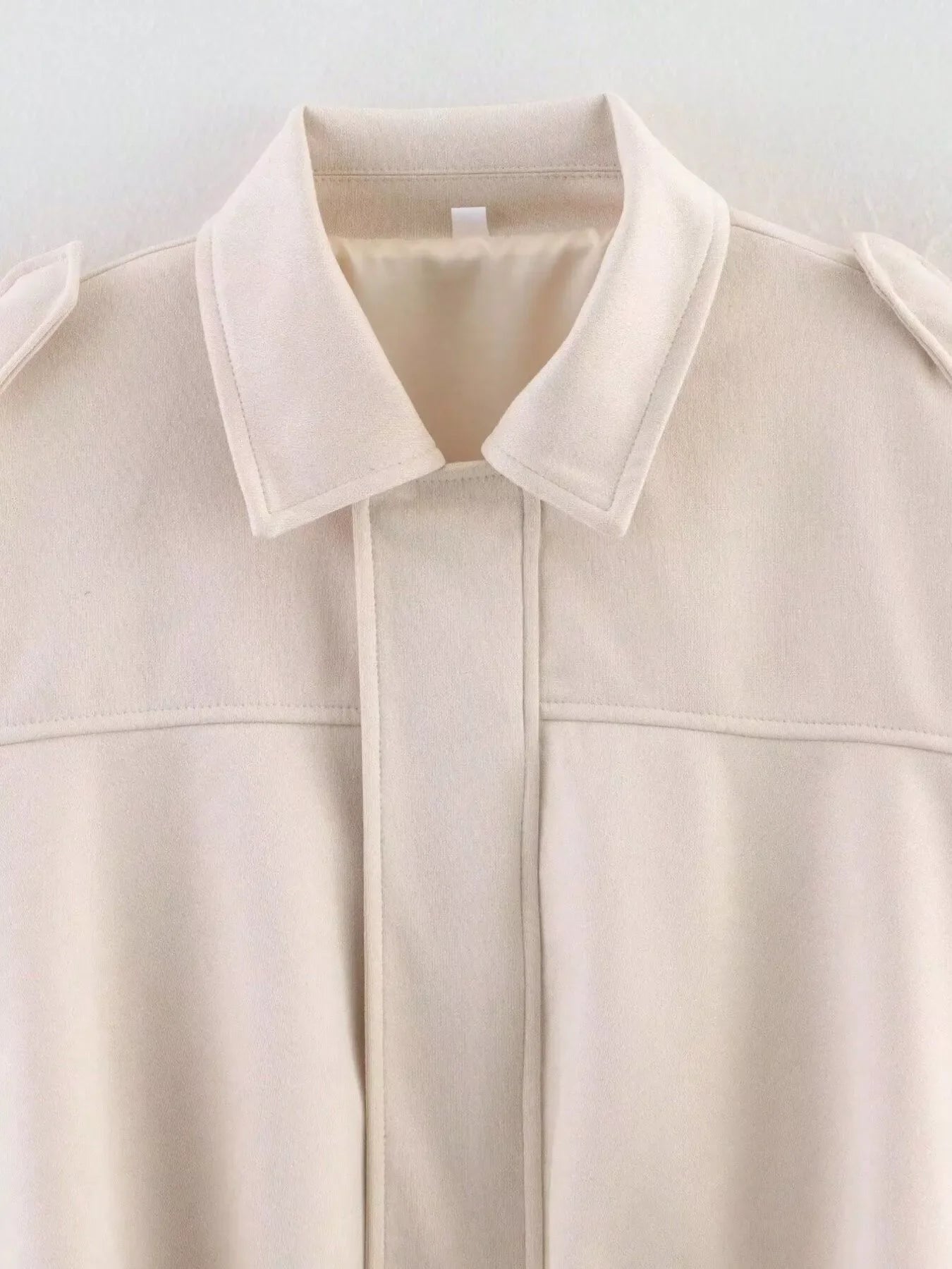 Off-white oversized zip-up jacket with collar and epaulets.