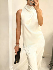 Ivory asymmetrical cami top with lace trim detail and cowl neck.