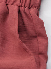 Ruffled waist palazzo trousers in rust with a side pocket detail.