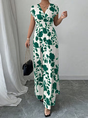 Floral surplice maxi dress with cap sleeves and smocked waist in white with green floral print.