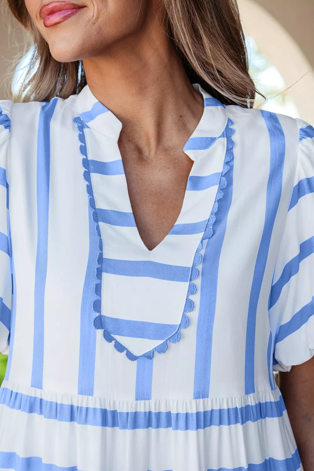 Tiered dress with blue and white stripes, ricrac trim, and ruffled details.