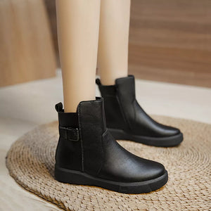 Chic black round toe ankle boots with decorative buckle detail and side zipper.
