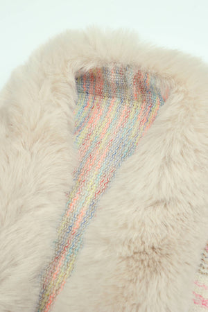 Textured knit cape in tan with a colorful striped lining and plush faux fur collar.
