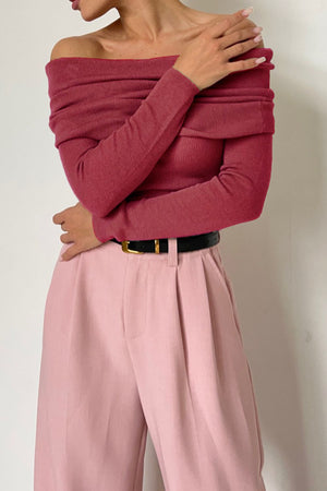 Deep Rose off-the-shoulder ribbed knit top with long sleeves, styled with pink wide-leg pants.