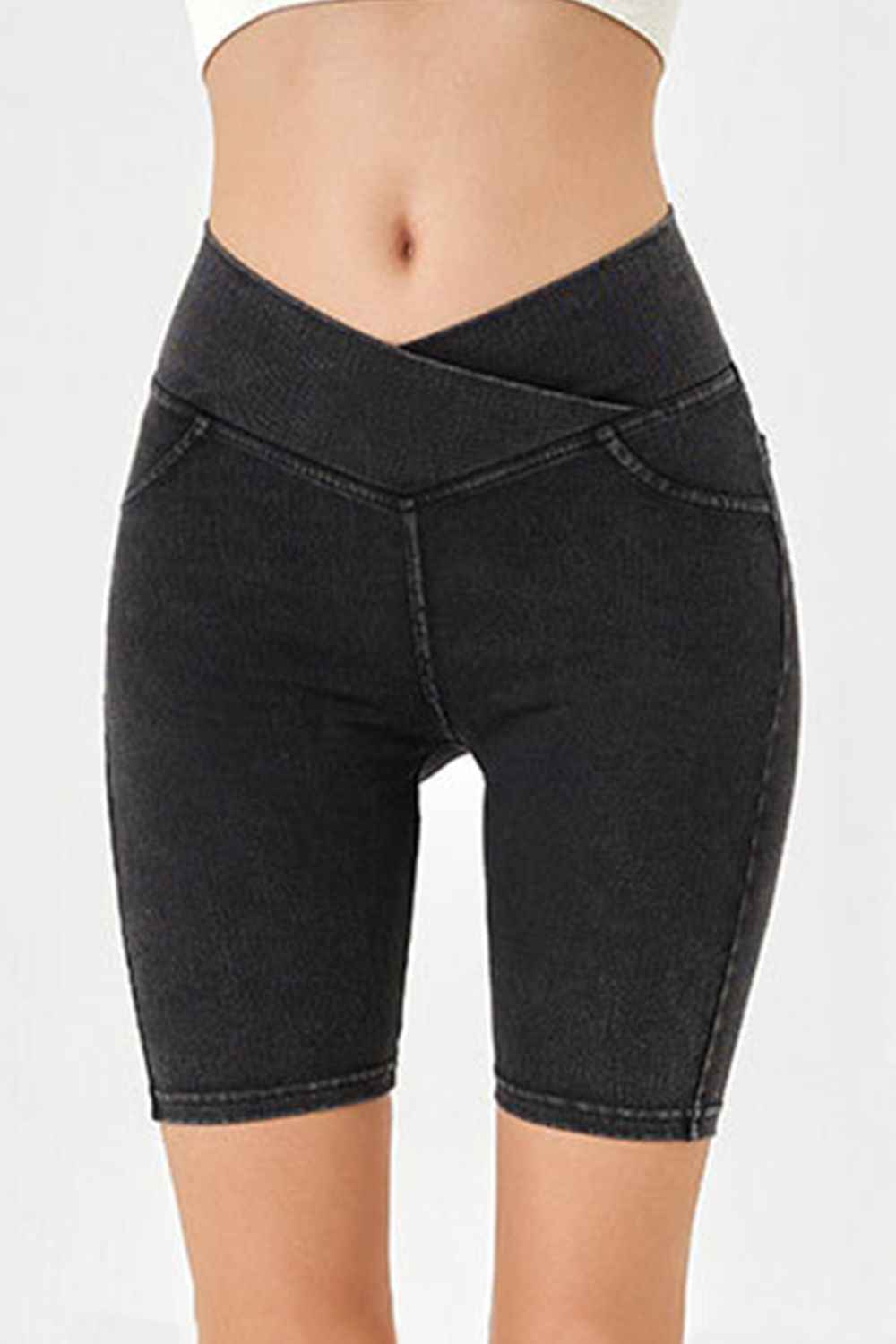 Black denim bermuda shorts with a crisscross waistband and a flattering cut.