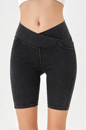 Black denim bermuda shorts with a crisscross waistband and a flattering cut.