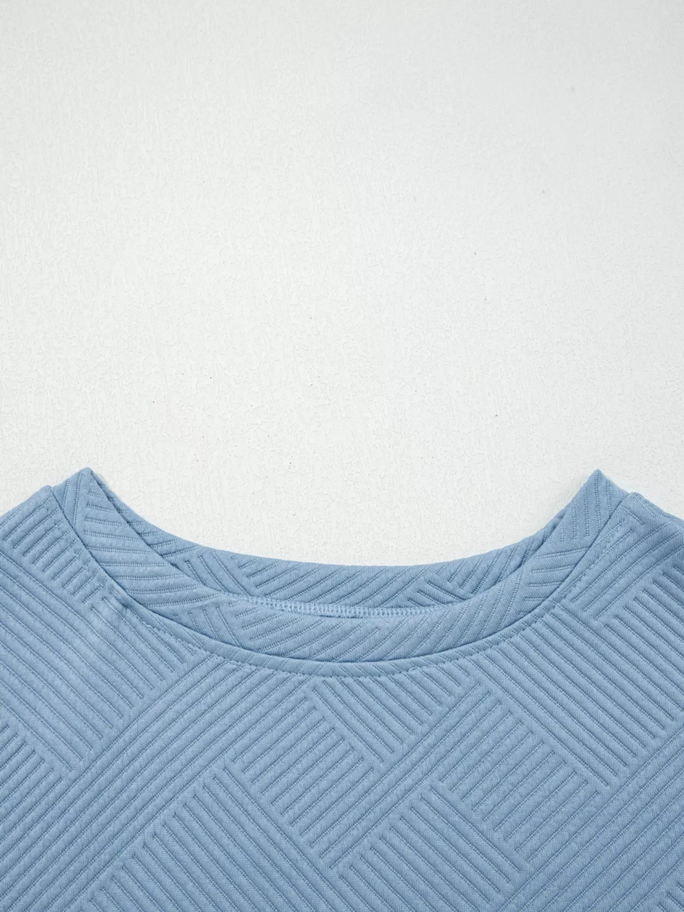 Light blue textured drawstring set with a geometric pattern and crew neck.