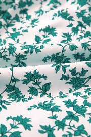Shirred cami maxi dress fabric with a white background and teal floral print.